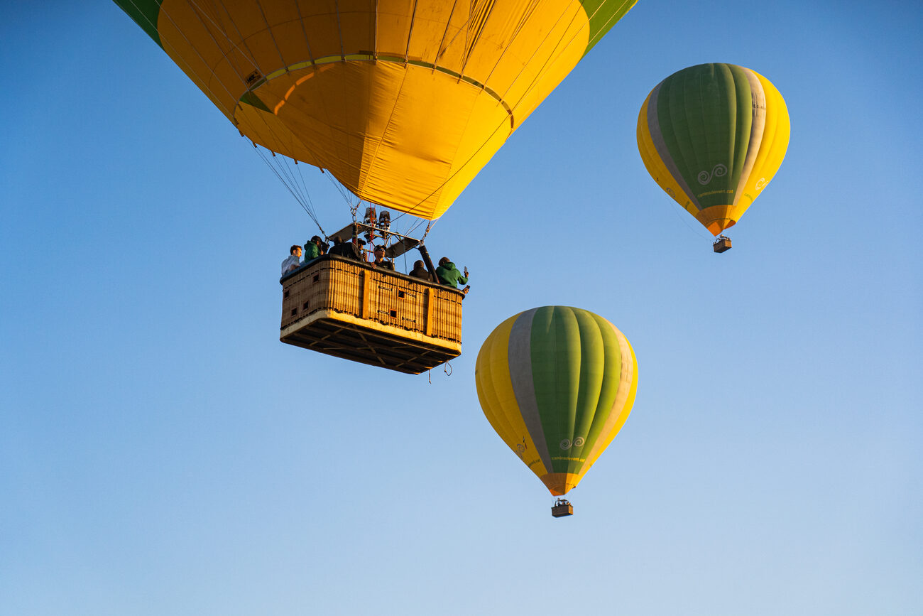 three hot air balloons flying over El Bages